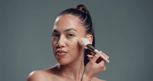 Beauty, woman and makeup brush on face in studio for blush application, powder and aesthetic