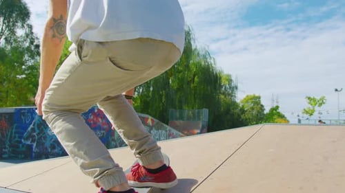 Skater performing tricks at a graffiti-covered skatepark