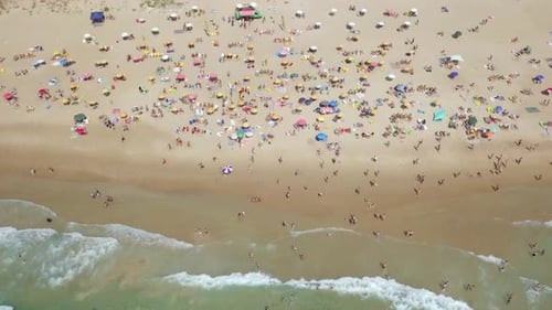 Mediterranean beach during summer with people in the water