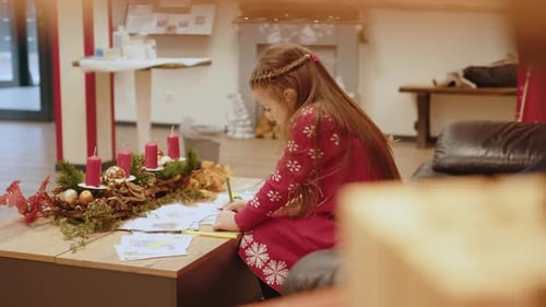 Girl Drawing Christmas Pictures at Home