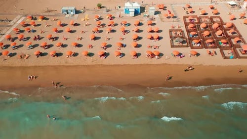 Orange Umbrellas and Sun Lounges on Sand Beach Near Venice