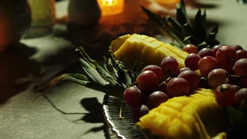 Fresh Pineapple and Grapes with Candlelight Glow