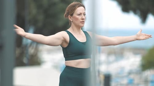 Woman Stretching in an Urban Park on Sunny Day