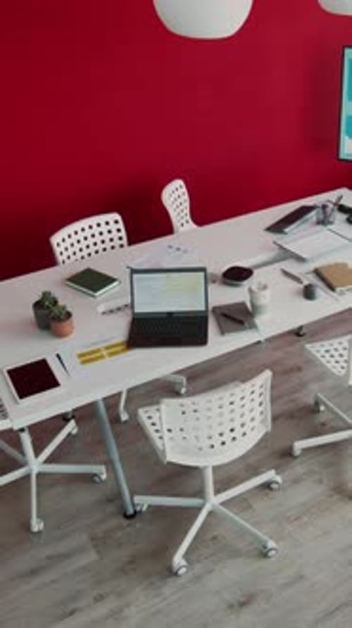 Top View of Meeting Room with Red Wall in Creative Agency during Discussion