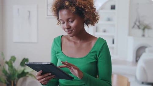 Woman Using Tablet in Modern Home Setting