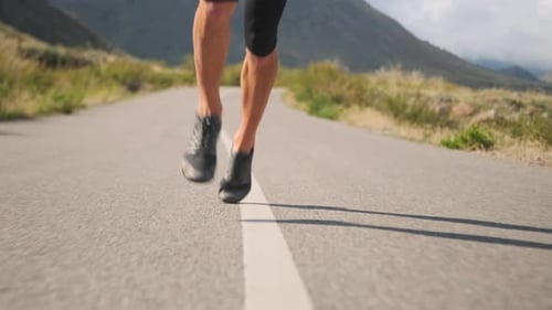Muscular Legs Drive an Athlete Through a Scenic Valley Showing Strength