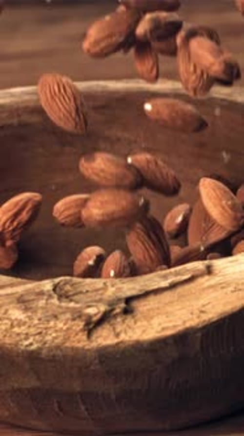 Almond Drops Wooden Bowl Filmed on a Highspeed Camera at 1000 Fps