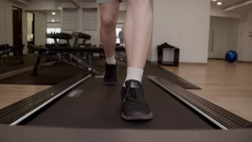 Extreme Close Up Highlights Single Footstep Hitting Treadmill Belt Showing Athletic Footwear and