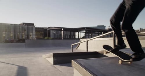 Skateboarder Performs Tricks in an Urban Skatepark