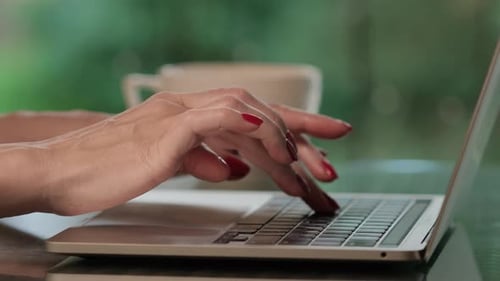 Woman Typing on Laptop Keyboard Close Up