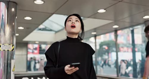 Japanese woman, happy and smartphone in city for connection and technology or wellness by outdoor