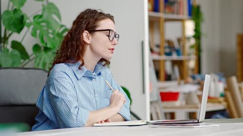 Woman Attending Video Conference in Office Setting