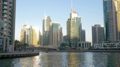 Dubai Marina waterways, handheld shot of small leisure boats sailing the canals