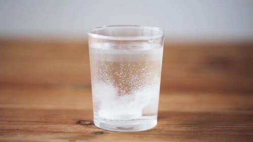 Effervescent Tablet Dissolving in Glass of Water