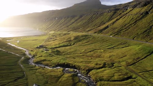 Aerial view of mountain and coastal road, Faroe Islands.