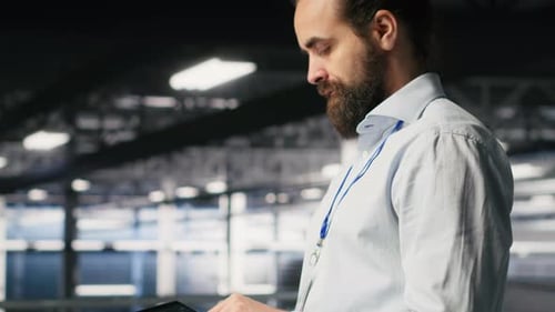 Programmers on Data Center Industrial Platform Checking Code on Tablet