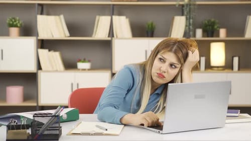 Overwhelmed businesswoman thinks.