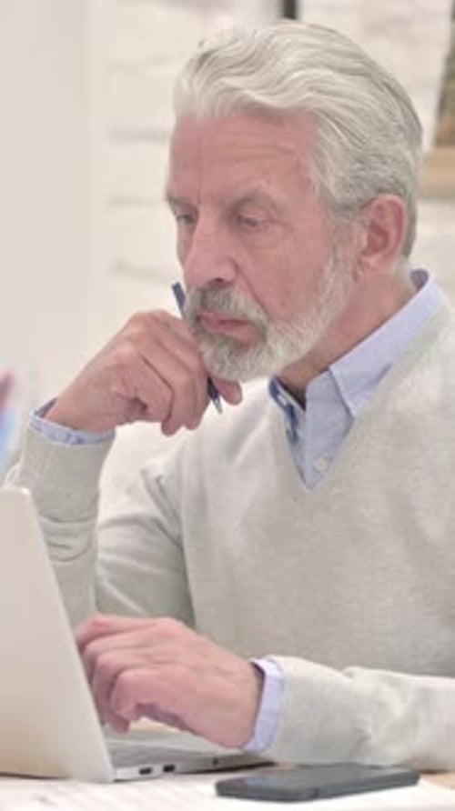 Senior Man Working on a Laptop