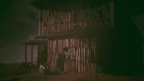 Abandoned Wooden Structure in a Desolate Landscape at Twilight