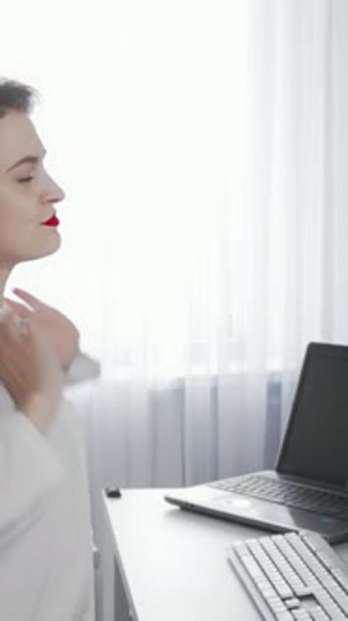 Woman Working at Desk Stretches