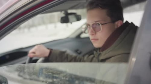 Young Adult in Car in Winter Weather