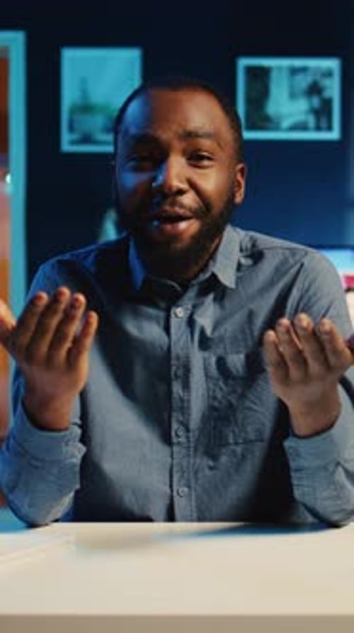 Adult Man Talking at Desk at Night