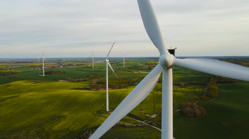 Scenic View of Wind Turbines Farm in Agricultural Field Rotating Blades of Windmill Close Up