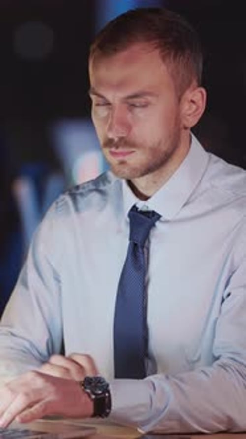 Serious Young Adult Man Working at Night