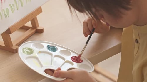 Child Painting a Colorful Flower on Canvas Art