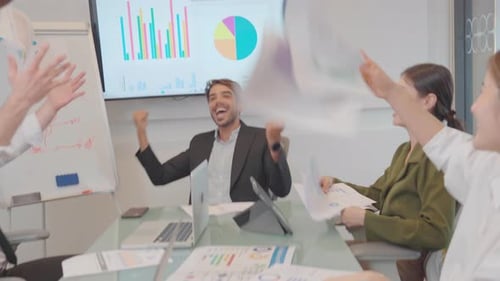 Happy Office Team Celebration with Documents