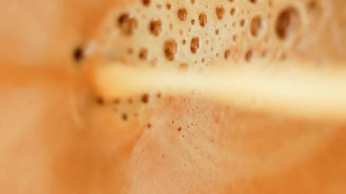 Macro Shot of Creamy Orange Drink with Bubbles