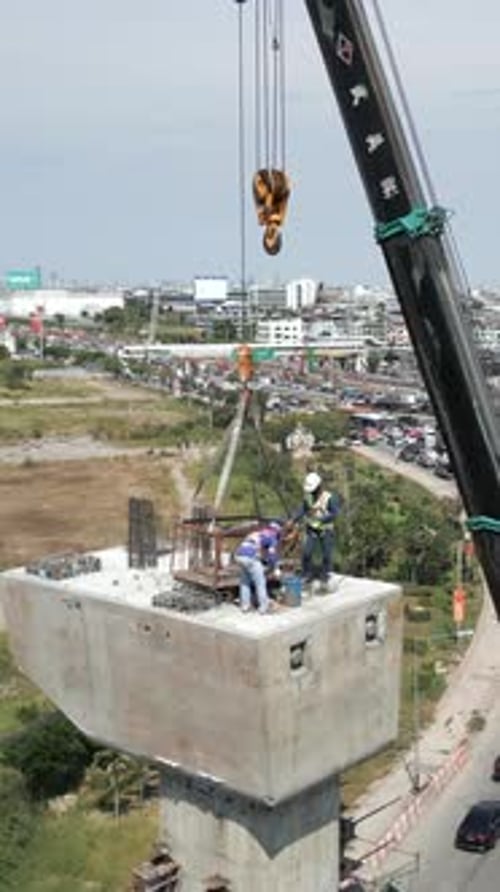 Drone View of Workers Placing Something on Top of a Beam