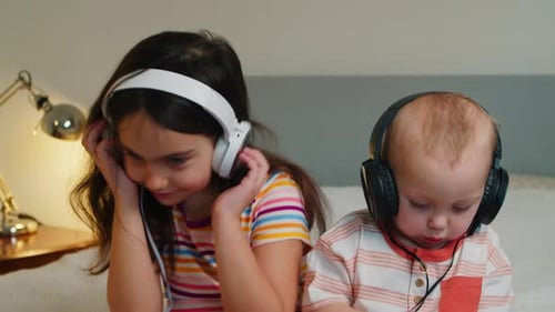 Children Listen to Music with Headphones at Home