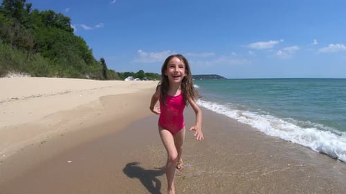 Slow Motion of Happy Playful Young Girl, Kid Running Barefoot in Pink Swimsuit on Sandy Beach