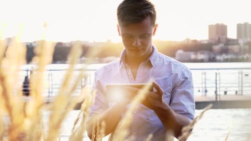 Young Businessman Using Tablet Screen Device in the City