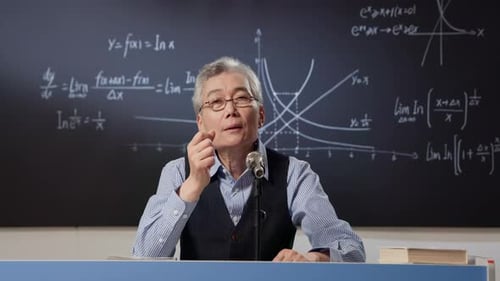 Mathematics intelligent stylish teacher wearing eyeglasses explaining math formulas chalk on green