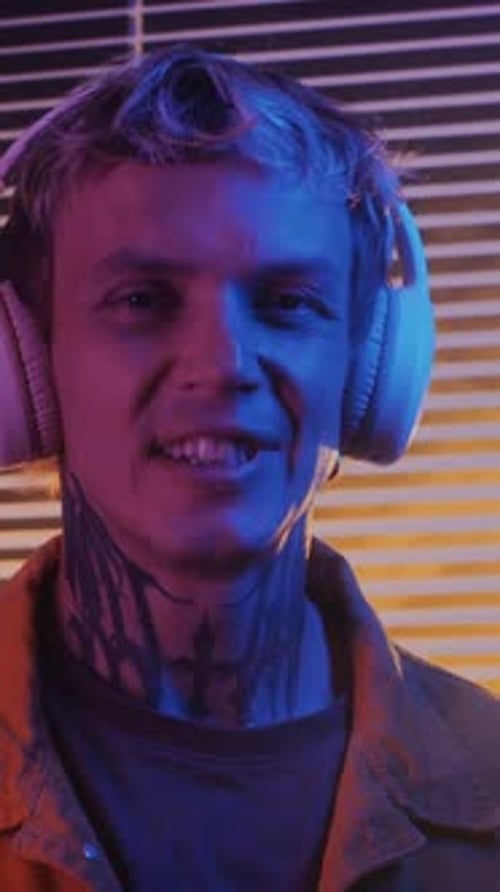Close Up Portrait of Tattooed Young Adult With Headphones