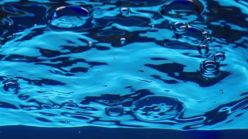 Bottom View of Air Bubbles Rising Up in Water Column and Forming Waves and Ripples on Surface
