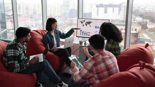 Specialists Conducting Data Analysis on Display in Office
