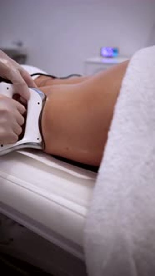 Woman Receiving Cellulite Treatment with a Device