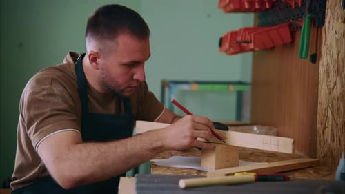Carpenter Measuring Wooden Plank in Workshop