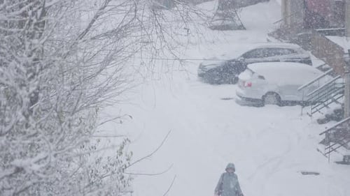 A Winter Blizzard Scene Depicts Heavy Snowfall with a Snowcovered Car in a Residential Area The