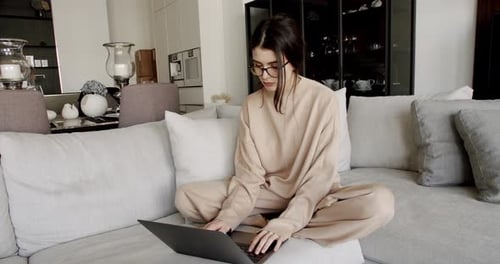 Woman Working on Laptop at Home