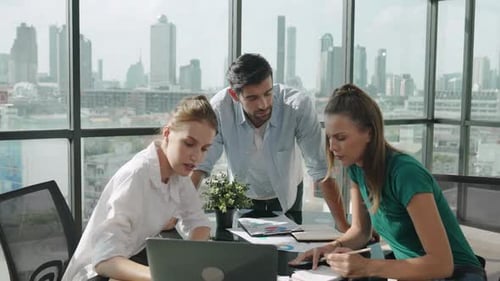 Team Discussing Data in an Office with City View
