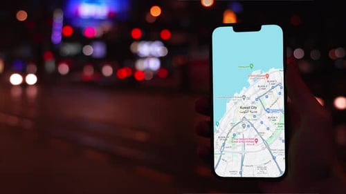 Smartphone Showing Kuwait City Map at Night