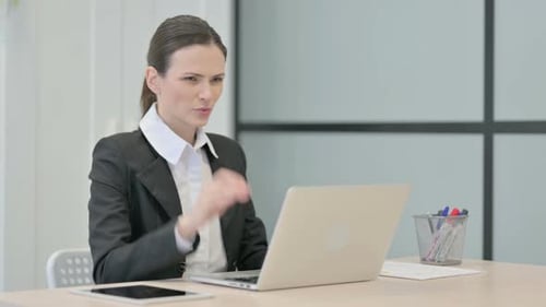 Woman Typing at Desk Rubs Aching Neck