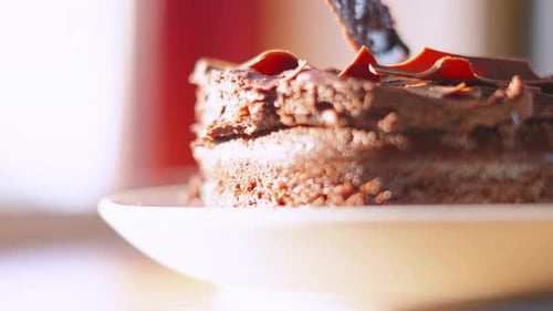 Slicing a decadent chocolate cake with a knife