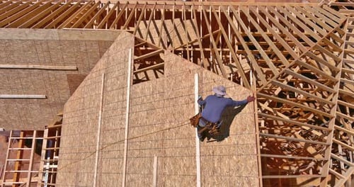 Construction Worker Building House Framework, Aerial View