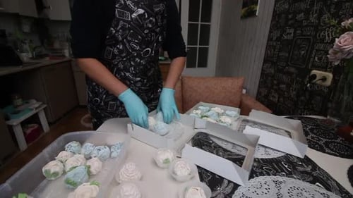 Baker Assembling Marshmallow Rose Desserts in Boxes