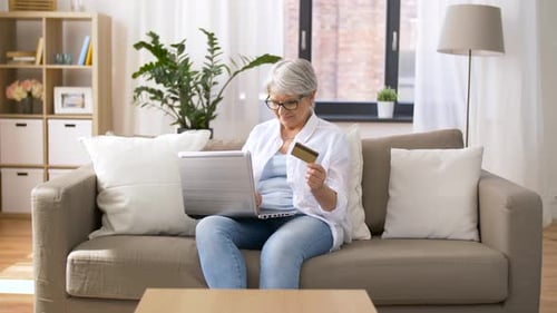 Senior Woman Shopping Online with Laptop at Home